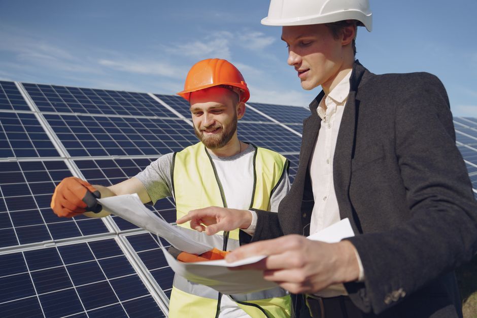 Solar energy consultant reviewing plans with homeowners